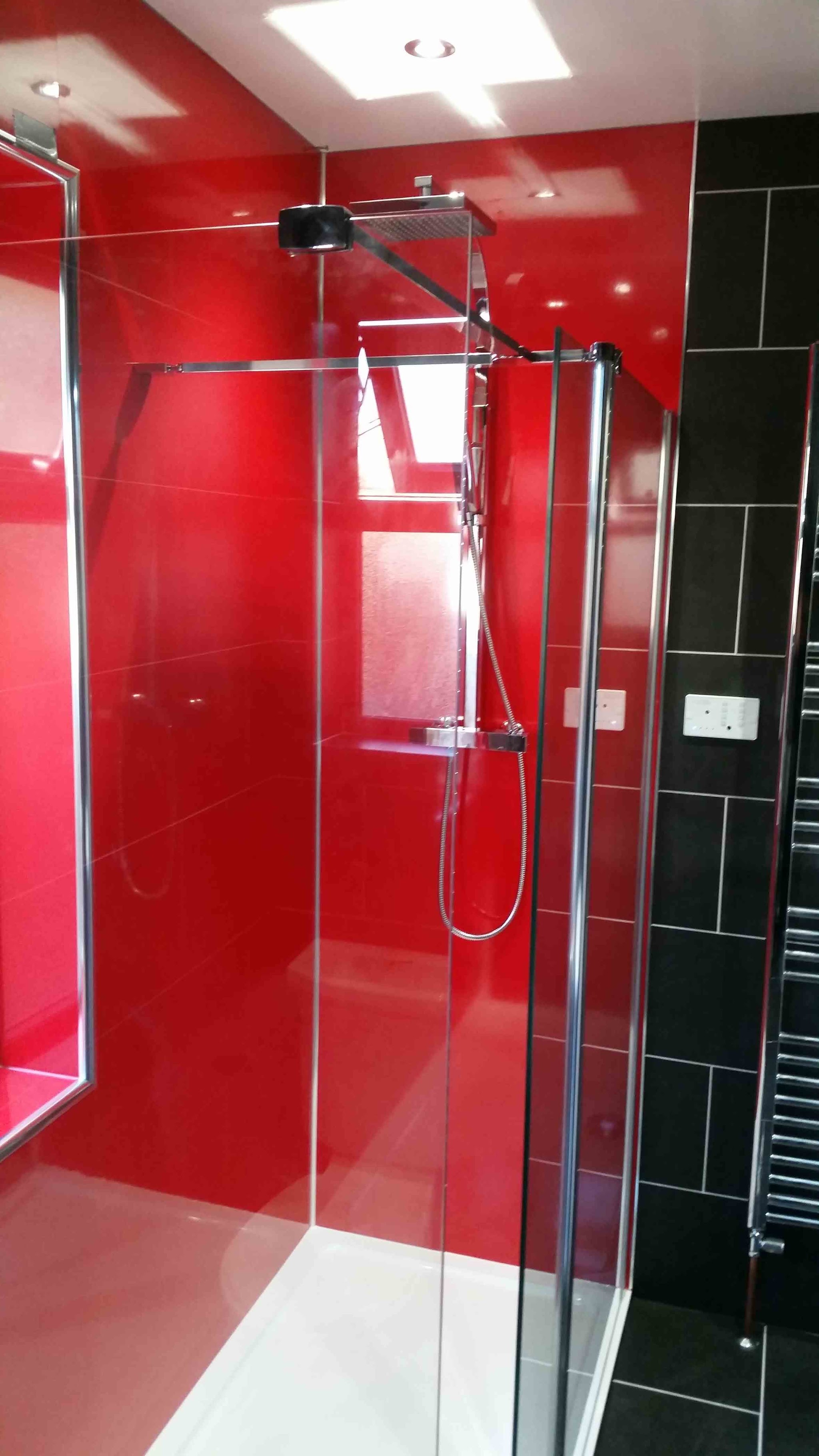 Shower enclosure with red glass wall panels