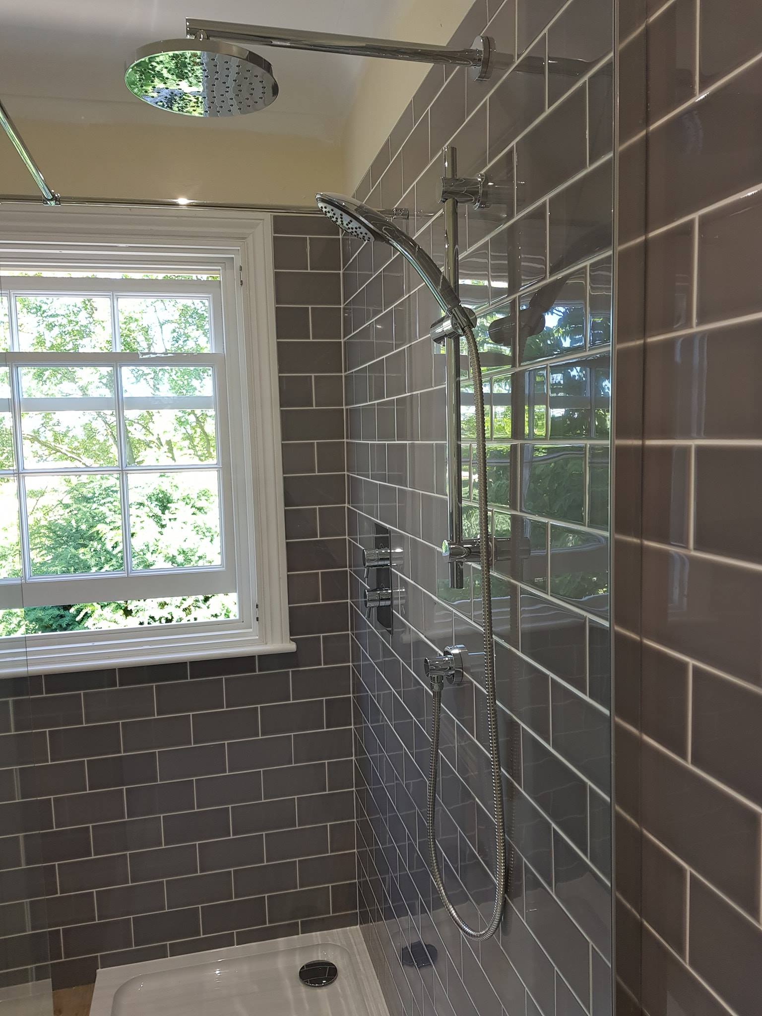 Ensuite rainfall shower with grey metro tiles