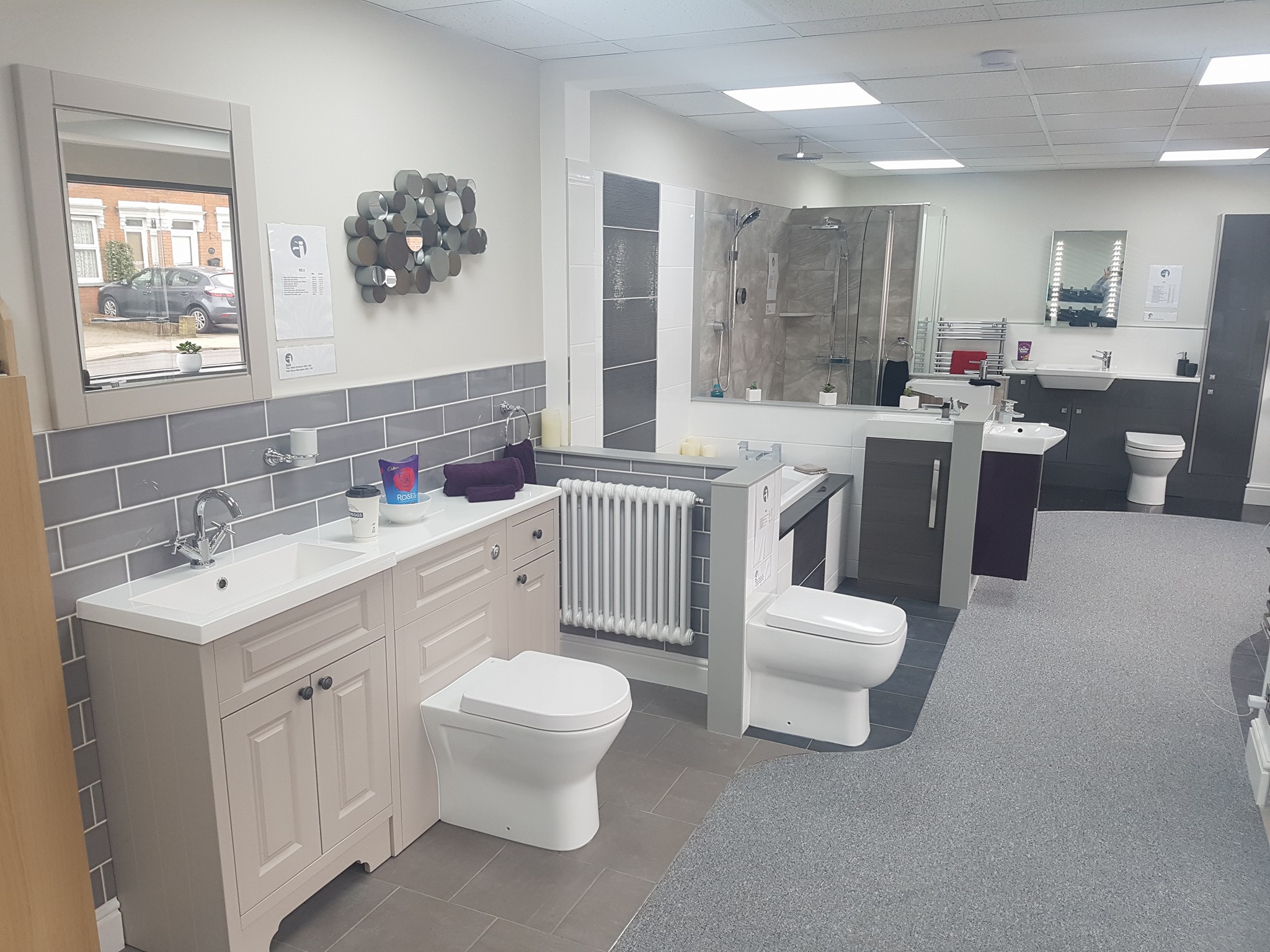 Inside the showroom: fitted vanity units, a WC and shower displays