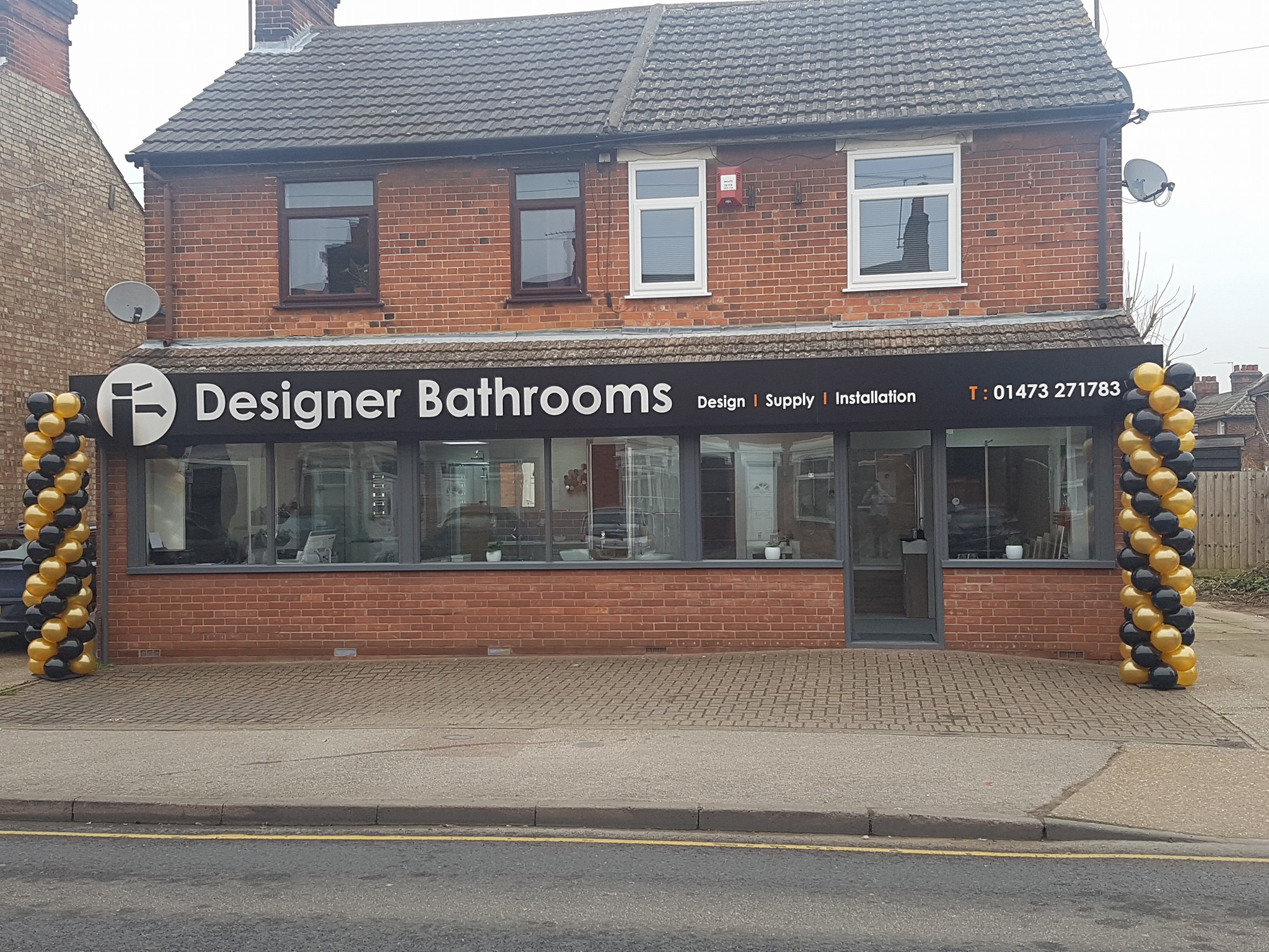 The Designer Bathrooms shopfront on Foxhall Road, with the sign reading Design, Supply, Installation