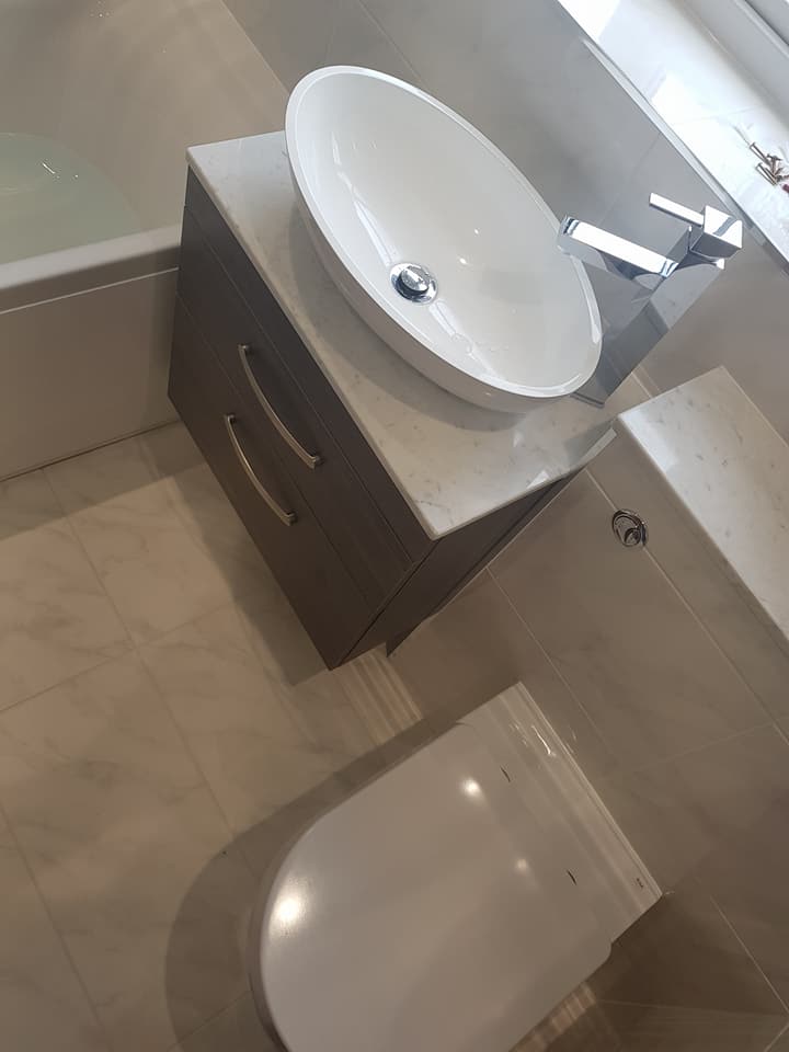 Countertop vessel basin on a dark vanity unit